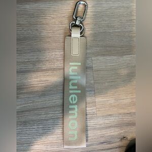 Lululemon never lost keychain! Tan background with  neon letters